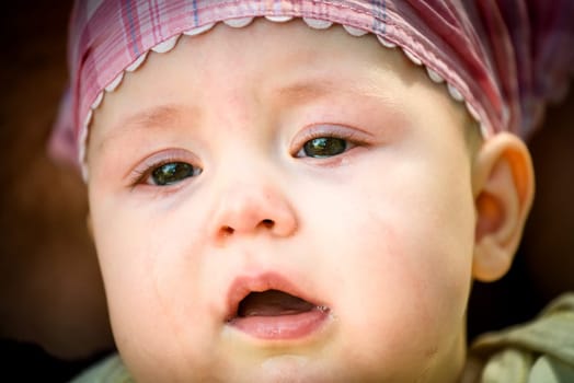 Unhappy baby portrait - detail of face, tears visible