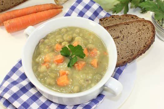 a white cup of pea stew and parsley