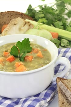 a white cup of pea stew and parsley