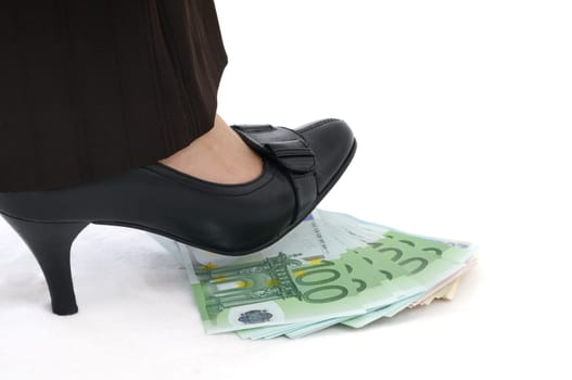 Leg stepping on banknotes (money under control - concept)