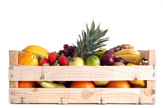 Various types of fruit stored in wooden box on white background