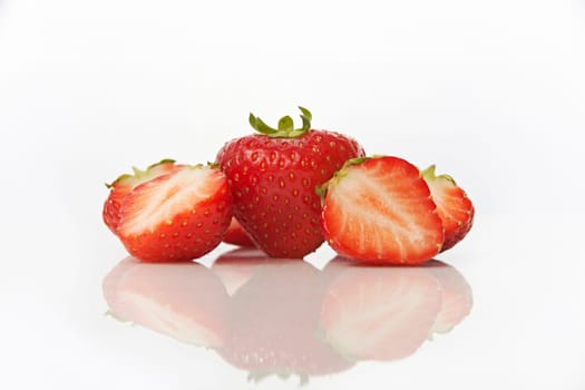Studio shot of strawberries on white background with reflection
