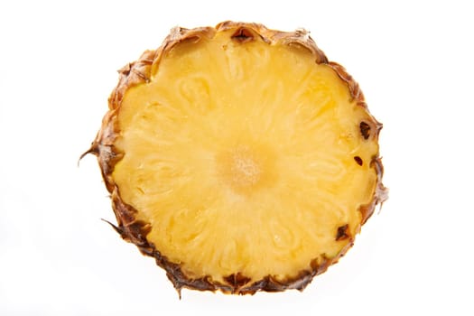 Overhead view of slice of pineapple on plain background