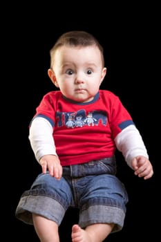 Baby boy on black background