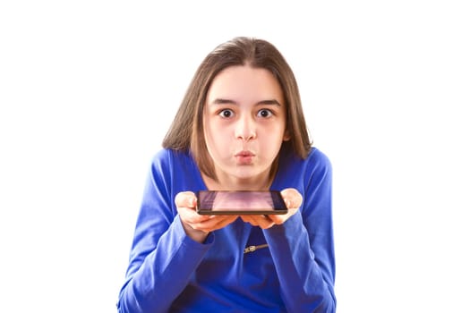Teenage girl blowing app icons from digital tablet.