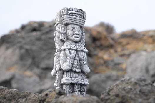 Ancient Maya Statue on the Rocks near Ocean