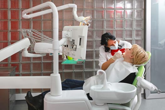 Female patient in chair at dentist office
