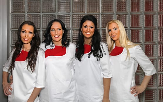 Four female dentist doctors in white uniforms