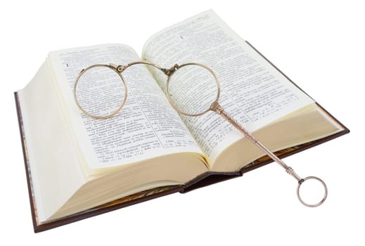 Open Hungarian book (bible) with old glasses, isolated on white.