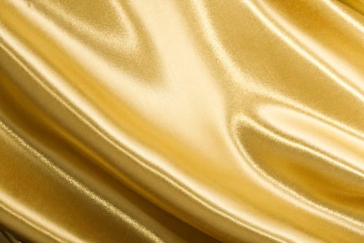 Golden satin or silk background with beautiful waves