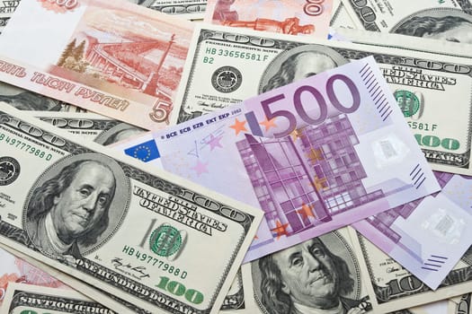 Lots of dollar and euro notes arranged in chaotic manner, background