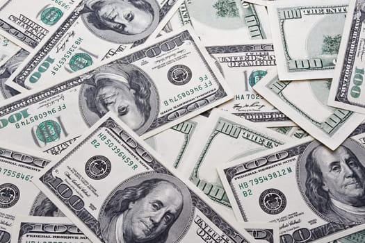 Lots of dollar notes arranged in chaotic manner, background
