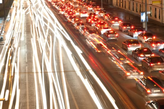 Road at night with traffic trails and blurred lights