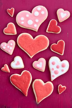 Colorful hearts on a red wooden background