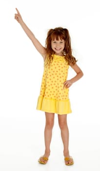 Full length photo of cute little girl pointing upward on white background