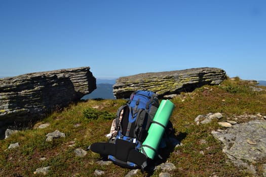.blue backpack in the mountains