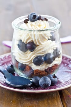 Creamy dessert in layers with fresh blueberries