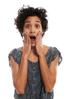 portrait of shocked hispanic girl with mouth open and hands on face, looking at camera on white background