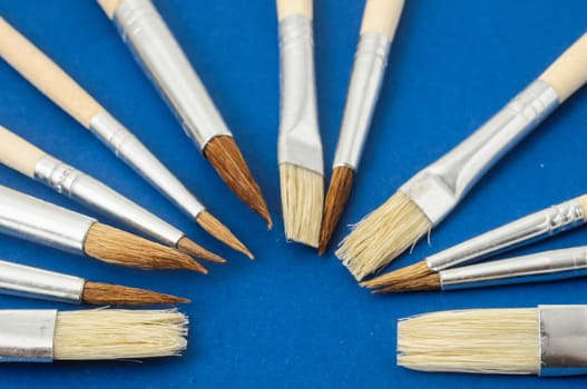 New Wooden Different Paintbrush Set Texture over a Colored Background