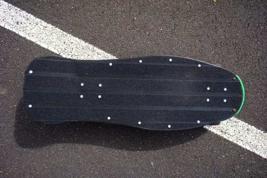 Vintage Style Longboard Black Skateboard on an Empty Asphalt Desert Road