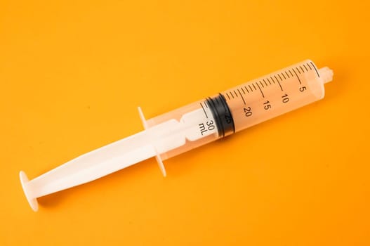 Big Black and White Syringe on a Colored Background
