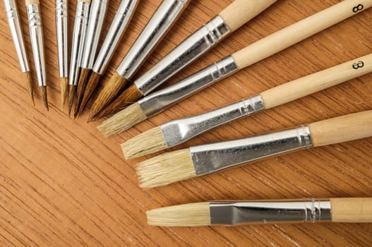 New Wooden Different Paintbrush Set Texture over a Colored Background