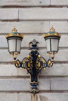 Ornate gilded lamp post at the Royal Palace in Madrid, Spain .