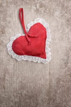 Red heart shape on a wooden background with space for text