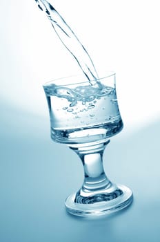 Pouring fresh water,healthy food and diet concept