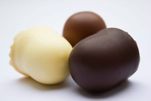 Chocolate covered dark brown, light brown and white marshmallows.