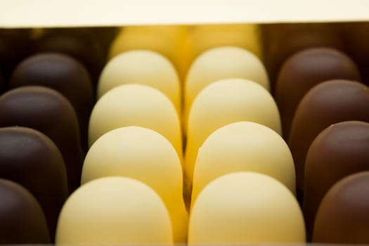 Chocolate covered dark brown, light brown and white marshmallows.