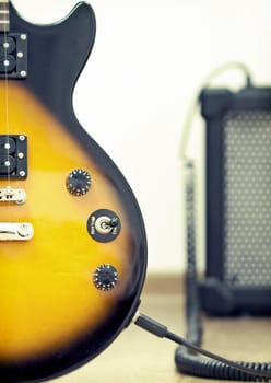 Guitar with amplifier in the background