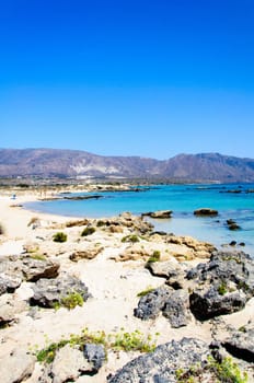 Elafonisi or Elafonissi, "deer island"" in Greek, is an island located close to the southwestern corner of the Mediterranean island of Crete, Greece. Elafonisi is an oblong, which often ""breaks"" in two parts by water giving the impression of being a separate island. The island is a protected nature reserve."