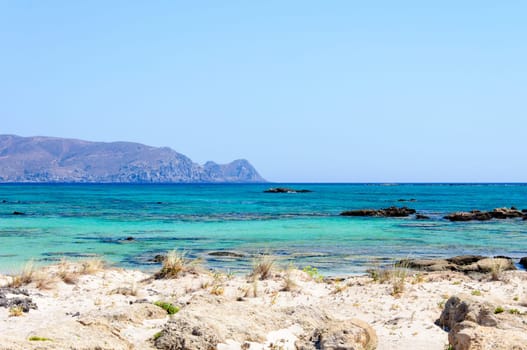 Elafonisi or Elafonissi, "deer island"" in Greek, is an island located close to the southwestern corner of the Mediterranean island of Crete, Greece. Elafonisi is an oblong, which often ""breaks"" in two parts by water giving the impression of being a separate island. The island is a protected nature reserve."