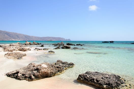 Elafonisi or Elafonissi, "deer island"" in Greek, is an island located close to the southwestern corner of the Mediterranean island of Crete, Greece. Elafonisi is an oblong, which often ""breaks"" in two parts by water giving the impression of being a separate island. The island is a protected nature reserve."