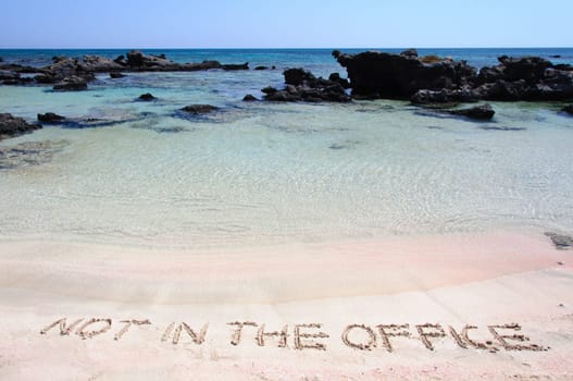 OUT OF OFFICE written on sand on a beautiful beacOUT OF OFFICE written on sand on a beautiful beach, blue waves in background, blue waves in background .Relax concept image