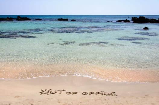 OUT OF OFFICE written on sand on a beautiful beach, blue waves in background .Relax concept image