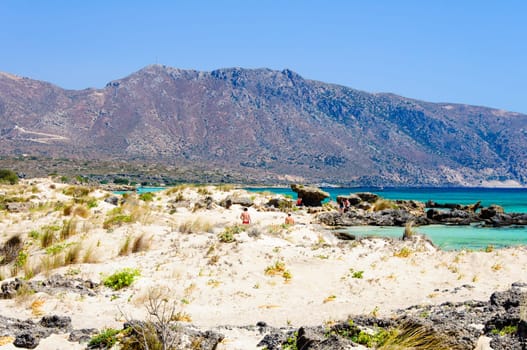 Elafonisi or Elafonissi, "deer island"" in Greek, is an island located close to the southwestern corner of the Mediterranean island of Crete, Greece. Elafonisi is an oblong, which often ""breaks"" in two parts by water giving the impression of being a separate island. The island is a protected nature reserve."