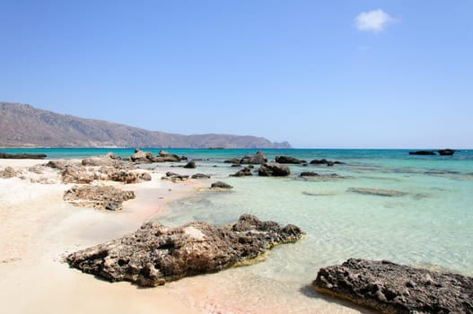 Elafonisi or Elafonissi, "deer island"" in Greek, is an island located close to the southwestern corner of the Mediterranean island of Crete, Greece. Elafonisi is an oblong, which often ""breaks"" in two parts by water giving the impression of being a separate island. The island is a protected nature reserve."