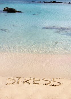 Word Stress written on sand, washed away by waves, relax concept
