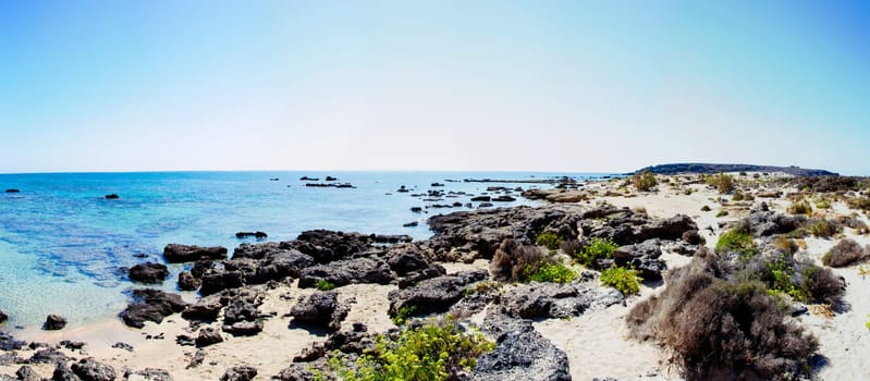 Elafonisi or Elafonissi, "deer island"" in Greek, is an island located close to the southwestern corner of the Mediterranean island of Crete, Greece. Elafonisi is an oblong, which often ""breaks"" in two parts by water giving the impression of being a separate island. The island is a protected nature reserve."