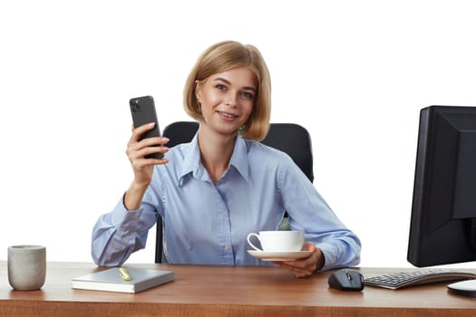 positive blonde business woman using phone, drinking coffee in the office