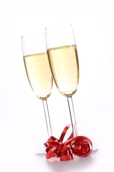Two glasses of sparkling wine with a red bow