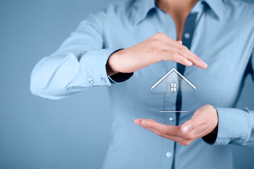 Property insurance and security concept. Protecting gesture of woman and symbol of house..