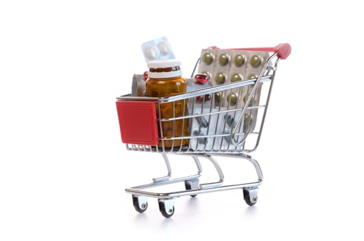 Shopping cart with pills and medicine isolated on white