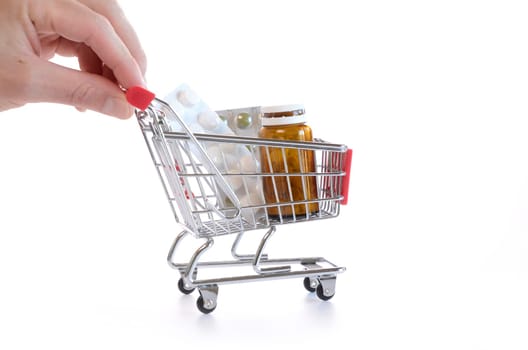 Shopping cart with pills and medicine isolated on white