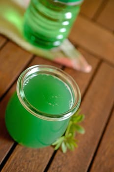 Woodruff liqueur on a wooden table