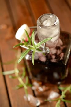 Cold bottle with juice of cherries and chrushed ice cubes