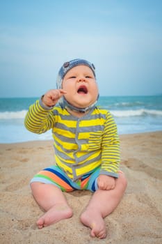 Cute baby sitting on a sand