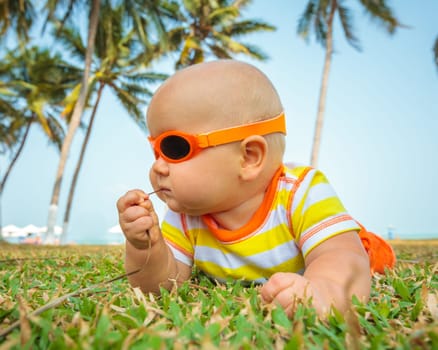 Cute baby relaxing on a grass